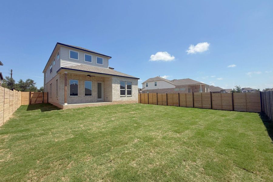 Expansive green lawn with a newly installed wood fence Expansive green lawn with a newly installed wood fence