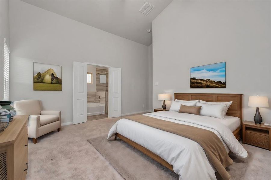 The secondary bedroom highlights the generous space and modern design. Plush carpeting adds comfort, while large windows invite plenty of natural light. The direct access to the ensuite bathroom ensures privacy and convenience, making this bedroom a true retreat within your home. **This image is from another Saratoga Home - Wren floorplan.**