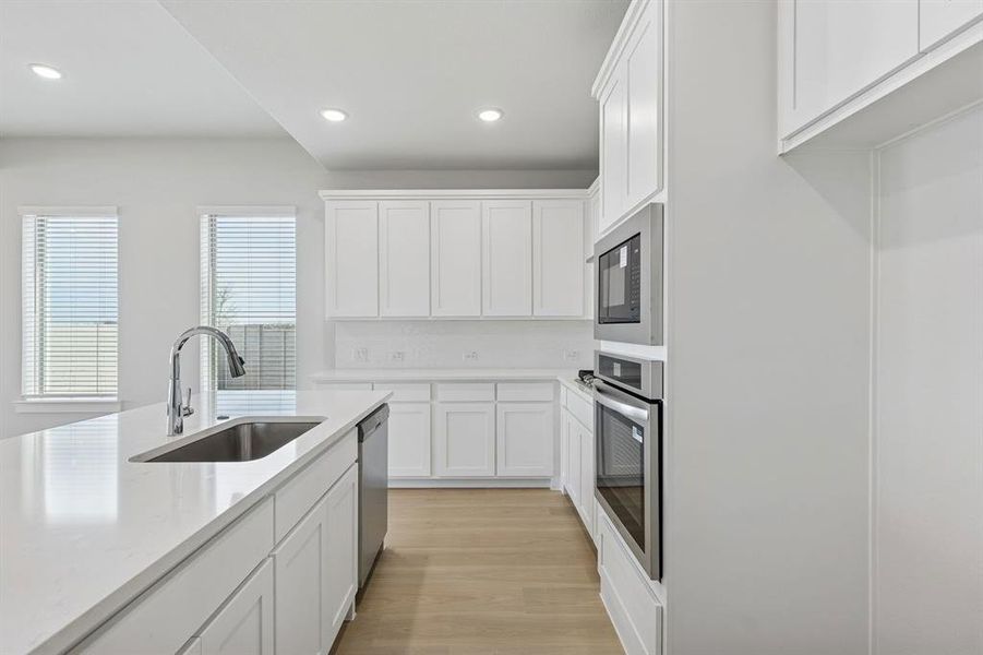 Kitchen in the Stanley II home plan by Trophy Signature Homes – REPRESENTATIVE PHOTO