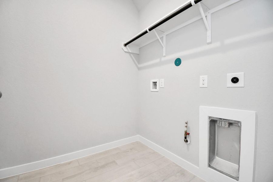 A perfect blend of functionality and comfort. Capture the essence of easy living with a first-floor laundry room, thoughtfully equipped with shelving for effortless organization. Both electric and gas connections available. A perfect blend of functionality and comfort. Capture the essence of easy living with a first-floor laundry room, thoughtfully equipped with shelving for effortless organization. Both electric and gas connections available.