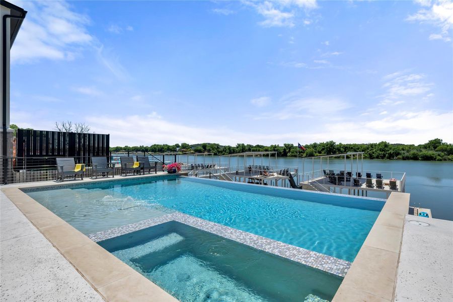 Modern pool with integrated spa, mosaic tile accents.