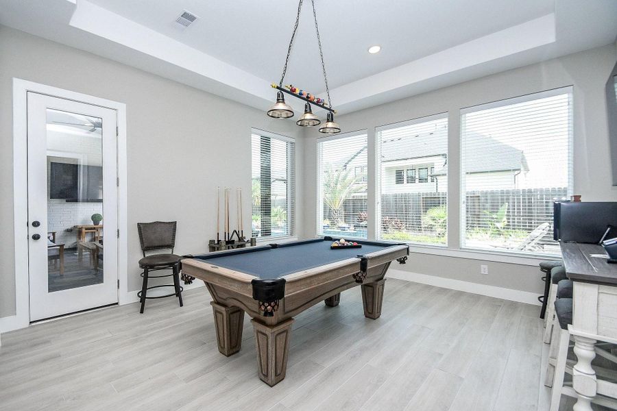 The game room is located between the covered back patio and the media room. The game room is located between the covered back patio and the media room.