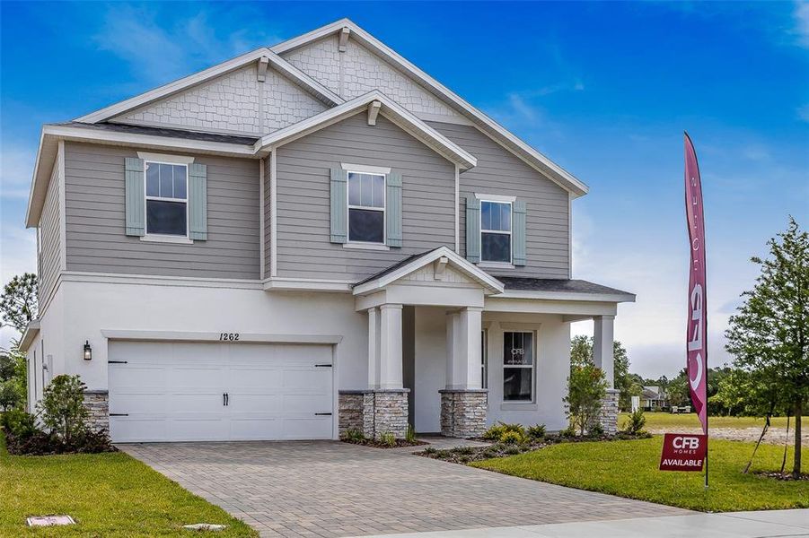 Front exterior of a new home in Gray Hawk at Hole Two, Daytona Beach, FL, highlighting curb appeal (Image 1). Front exterior of a new home in Gray Hawk at Hole Two, Daytona Beach, FL, highlighting curb appeal (Image 1).