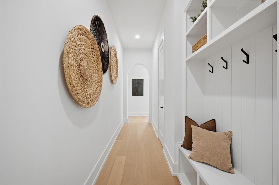 Mudroom with lockers and arched doorway that leads to the living area.