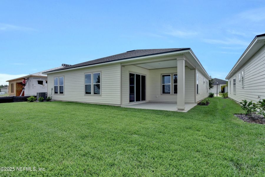 Front exterior of a new home in Reverie at Silverleaf, St. Augustine, FL, highlighting curb appeal (Image 14).