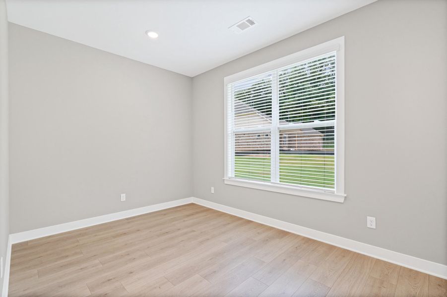 Bright interior space featuring light wood-finish flooring, neutral wall tones, and white trim Bright interior space featuring light wood-finish flooring, neutral wall tones, and white trim