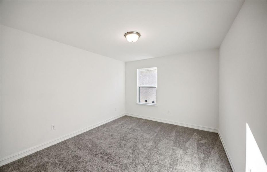 Spacious secondary bedroom with ample closet space  *real home pictured