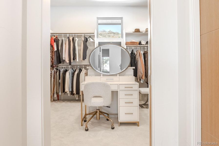 The dressing closet rivals a boutique, fitted with custom storage and designer lighting worthy of a style influencer.