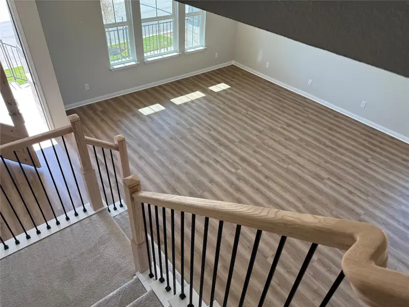 Staircase with baseboards and wood finished floors Staircase with baseboards and wood finished floors
