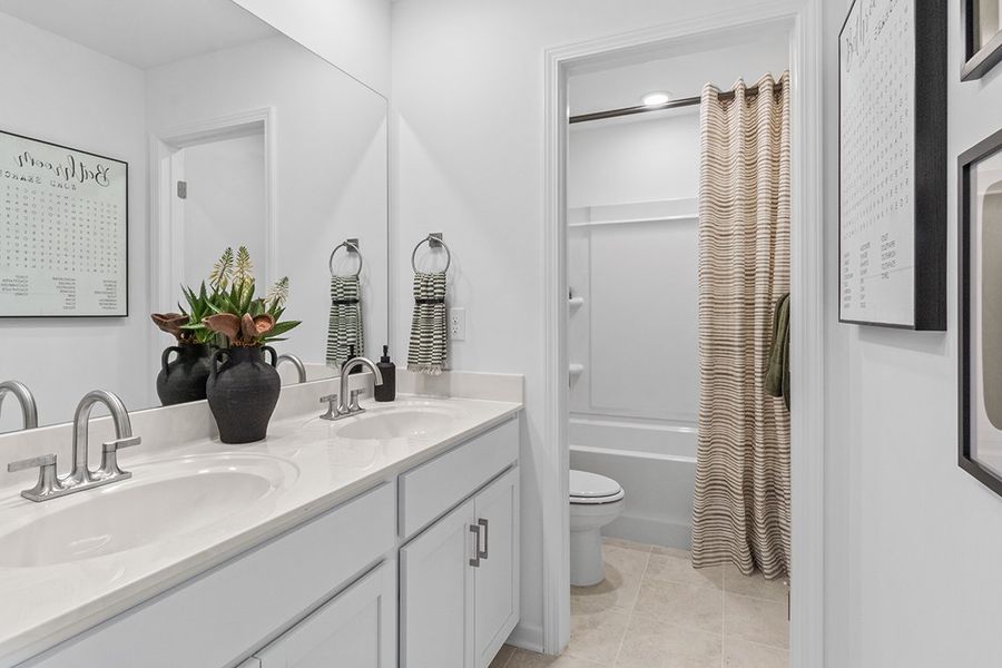 A bathroom with a shower and sink.