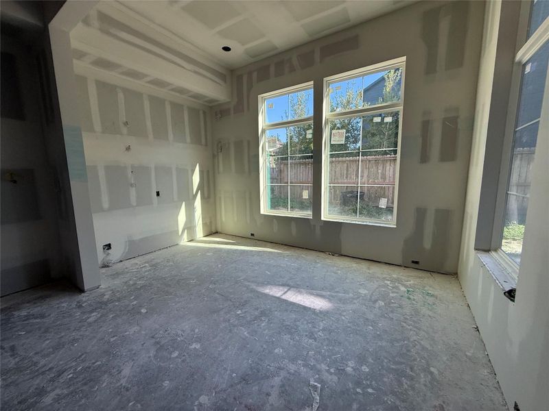 Formal dining area with lots of natural light. Shelving and custom cabinetry with reeded glass upper cabinet doors to be built.