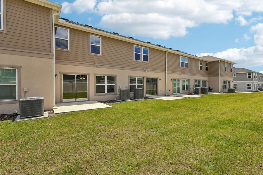Exterior details and patio area of a home in Reserve at Forest Lake Townhomes, Lake Wales (Image 3).