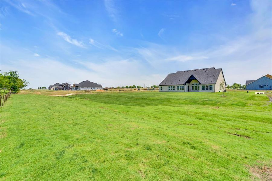 View of yard with a rural view