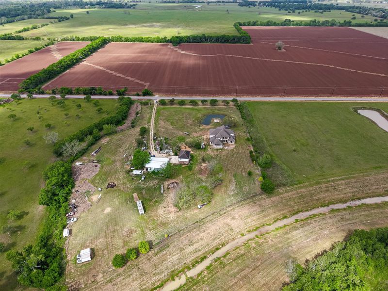 Aerial perspective of the property with wide-open land and scenic rural surroundings.