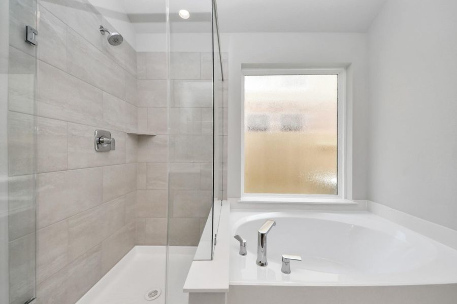 Experience a spa-like escape right in the heart of your primary bathroom! Sample photo of completed home with similar floor plan. Actual colors and selections may vary.