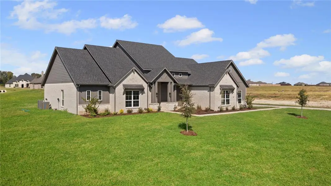 Front exterior of a new home in Tuscan Estates (1 Acre Lots), Waxahachie, TX, highlighting curb appeal (Image 1).