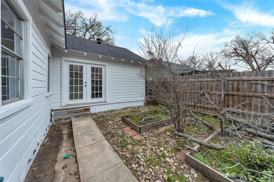 View of yard with a vegetable garden and french doors View of yard with a vegetable garden and french doors