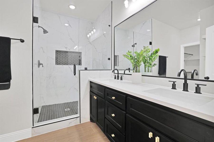 Bathroom featuring vanity, an enclosed shower, and hardwood / wood-style flooring