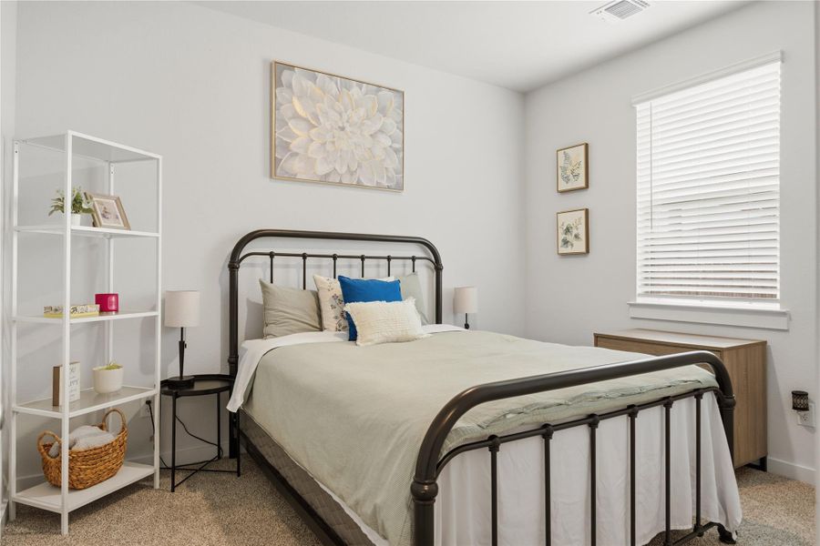Bedroom with light carpet