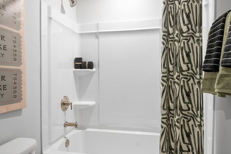 A bathroom with a shower curtain.