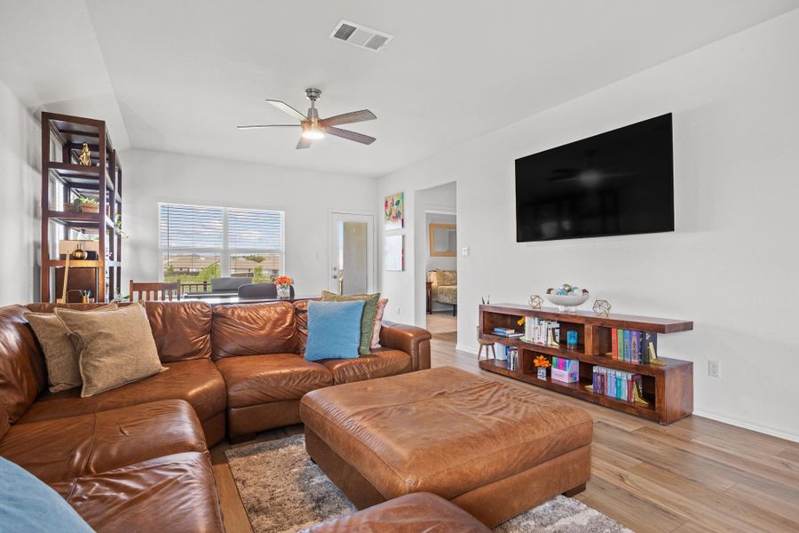 Gather in this inviting living space featuring resilient LVP woodgrain flooring and ample natural illumination. Gather in this inviting living space featuring resilient LVP woodgrain flooring and ample natural illumination.