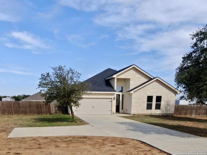 Front exterior of a new home in , Lytle, TX, highlighting curb appeal (Image 19).