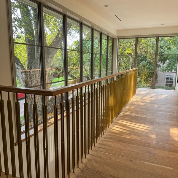 Light follows you up onto the second floor. A brass-railed gallery wall of windows turns the walk to the second floor into one of the best views in the house. Light follows you up onto the second floor. A brass-railed gallery wall of windows turns the walk to the second floor into one of the best views in the house.