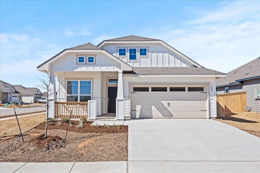 Front exterior of a new home in Trace, San Marcos, TX, highlighting curb appeal (Image 22).