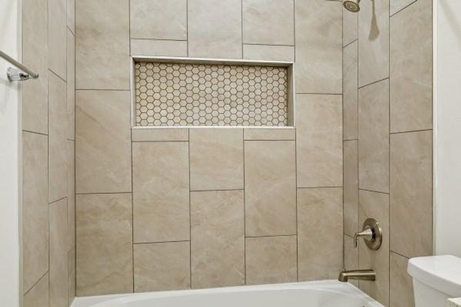 Elegant shower with a stylish built-in niche, featuring sleek hexagonal mosaic tiles for added sophistication and functionality. Elegant shower with a stylish built-in niche, featuring sleek hexagonal mosaic tiles for added sophistication and functionality.