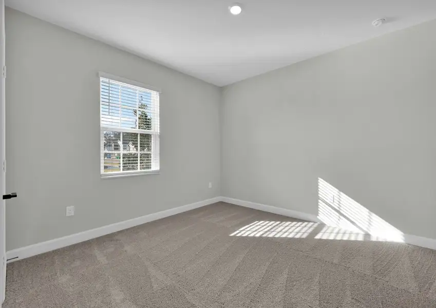Each secondary bedroom includes bright windows, carpet and a closet
