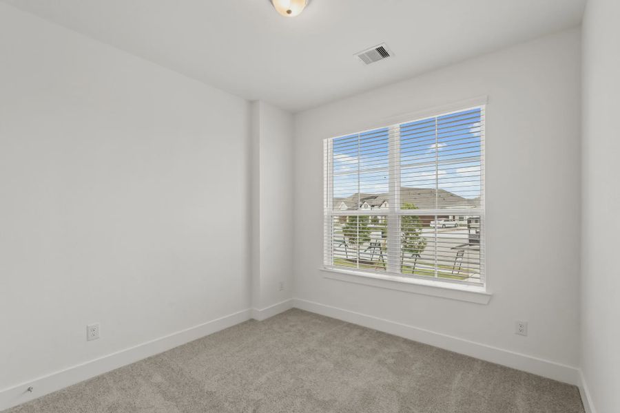 Representative unfurnished interior of a home built from the Chalet by Chesmar Homes in Meridiana Townhomes, Iowa Colony (Image 38).