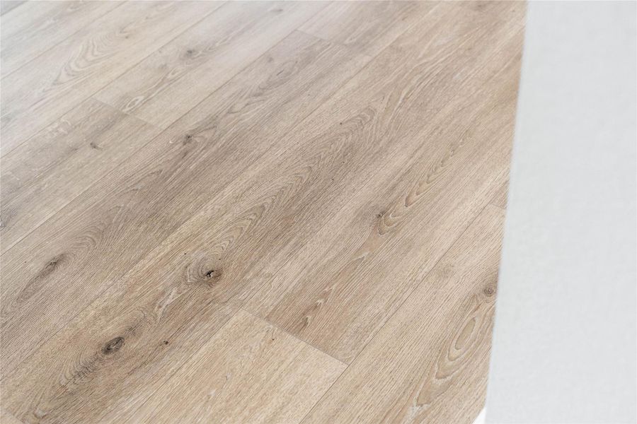 The photo highlights the Revwood laminate flooring in Sail Cloth which flows throughout the main living areas.