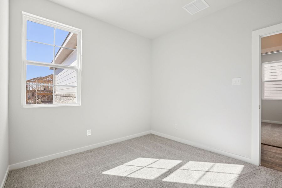 A room with a window and a tile floor. A room with a window and a tile floor.