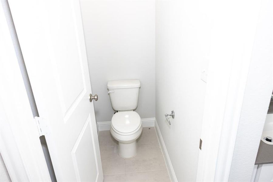 Bathroom with tile patterned flooring and toilet Bathroom with tile patterned flooring and toilet