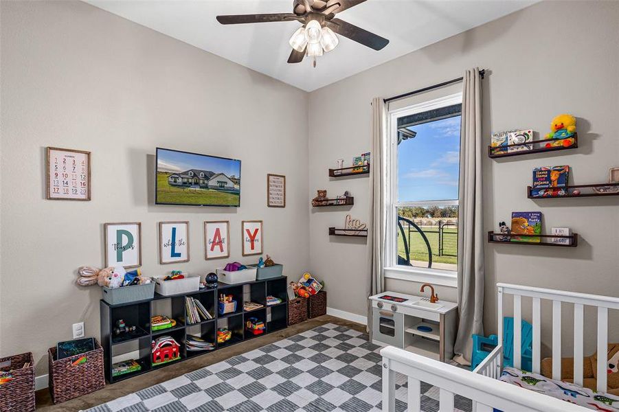 Playroom featuring baseboards and a ceiling fan Playroom featuring baseboards and a ceiling fan