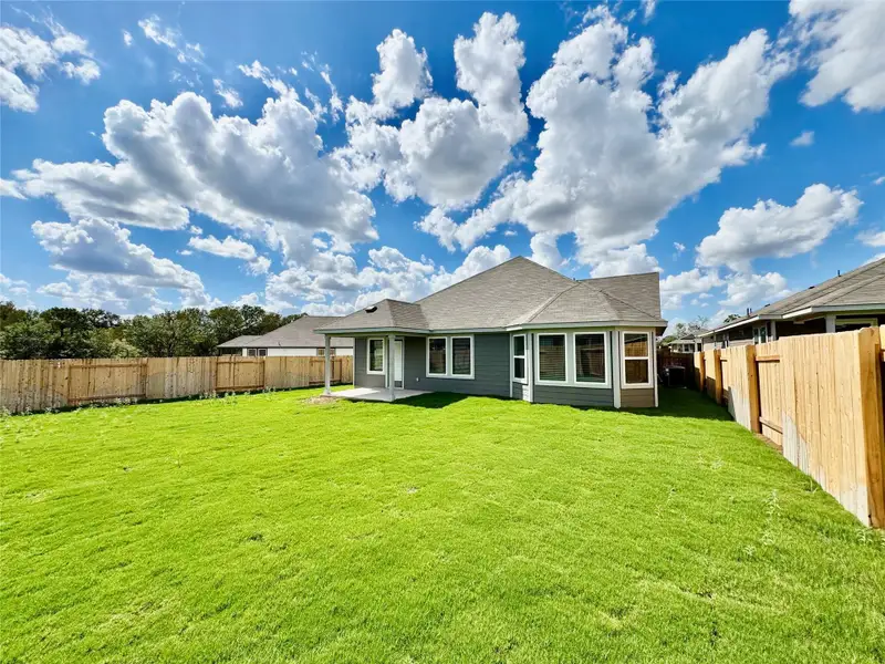 Back of house featuring a patio area, a fenced backyard, and a shingled roof