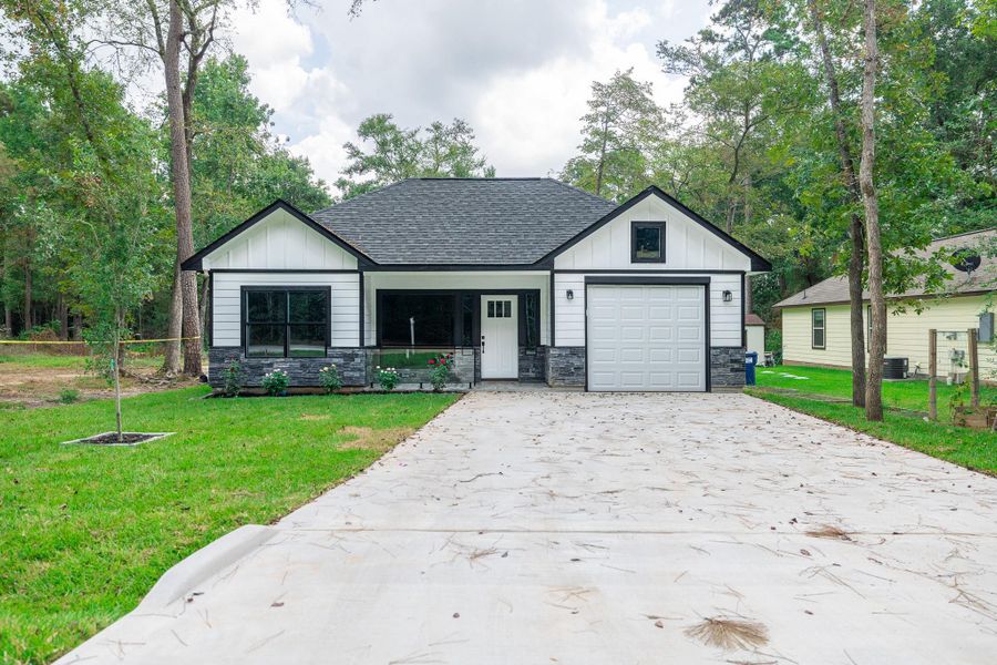 Front exterior of a new home in , Willis, TX, highlighting curb appeal (Image 21).