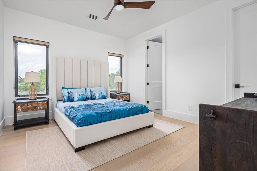 Bedroom three upstairs is generously sized, offering a walk-in closet and an elegant en suite bath. Bedroom three upstairs is generously sized, offering a walk-in closet and an elegant en suite bath.