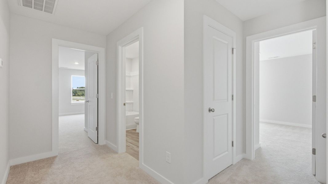 Hallway showcasing several rooms and bathroom