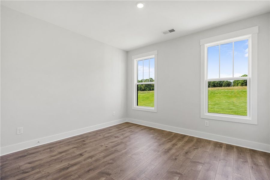 Hardwood floors and generous windows frame verdant