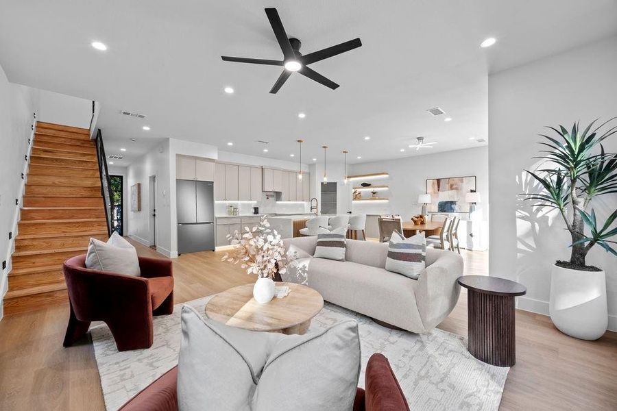 Living room with light hardwood / wood-style flooring and ceiling fan