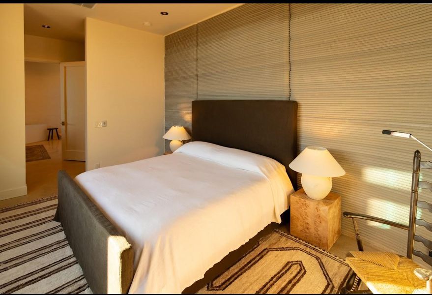 Bedroom with an accent wall and baseboards