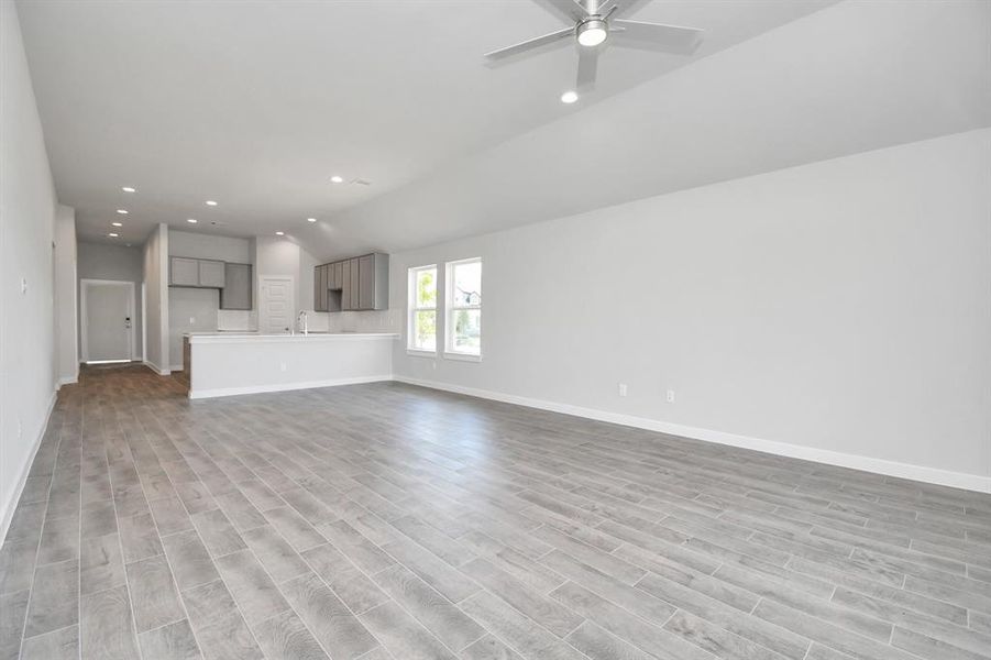 Another view of the family room. (Front door pictured is temporary). Representation of completed home with similar plan. Actual color and selections will vary.