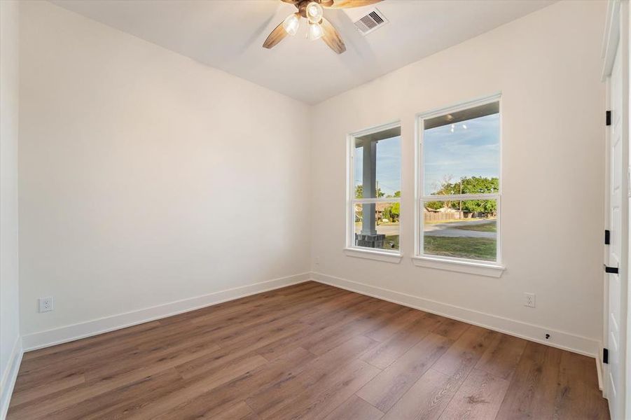 4th bedroom with front facing windows, a ceiling fan, and guess what? It also comes with a walk in closet!