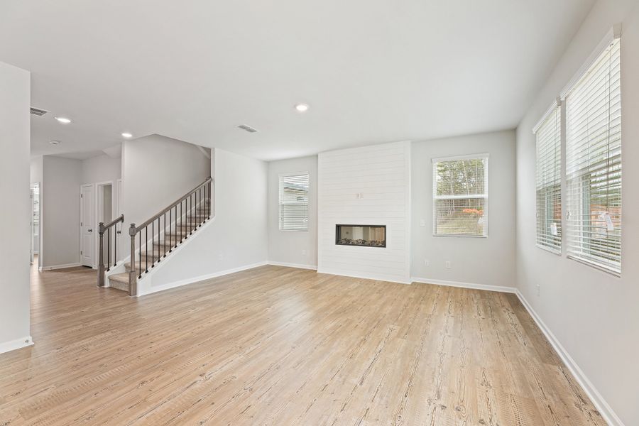 A large empty room with a wood floor and white walls. A large empty room with a wood floor and white walls.