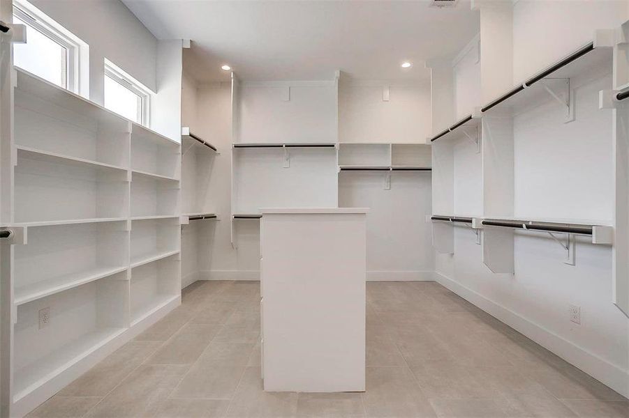 Walk in closet featuring light tile patterned floors Walk in closet featuring light tile patterned floors