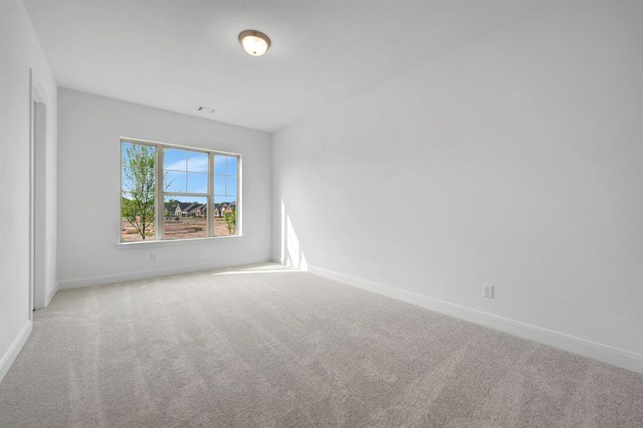 Spare room with light colored carpet and baseboards Spare room with light colored carpet and baseboards