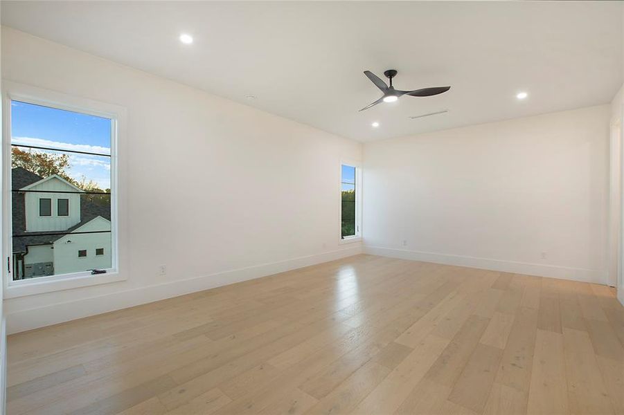 Spare room featuring ceiling fan and light hardwood / wood-style floors