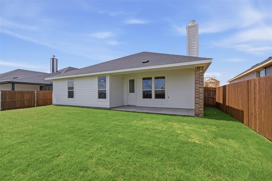 Expansive green lawn surrounds the rear of the property Expansive green lawn surrounds the rear of the property