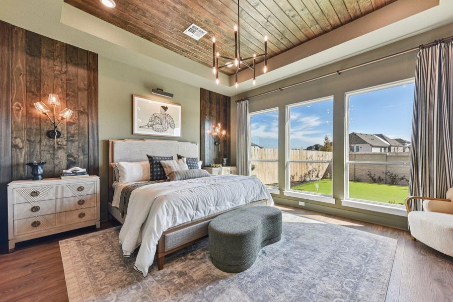 Rich wood plank ceilings and matching accent panels frame large windows overlooking the yard.